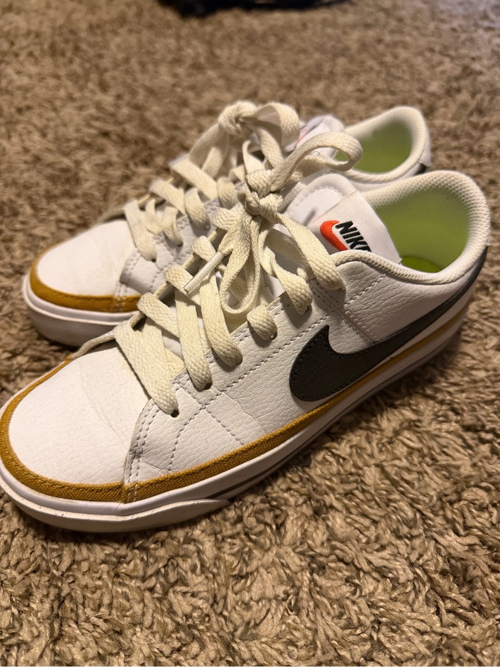 Nike Kids White Leather Sneakers with Black Swoosh and Gold Accent